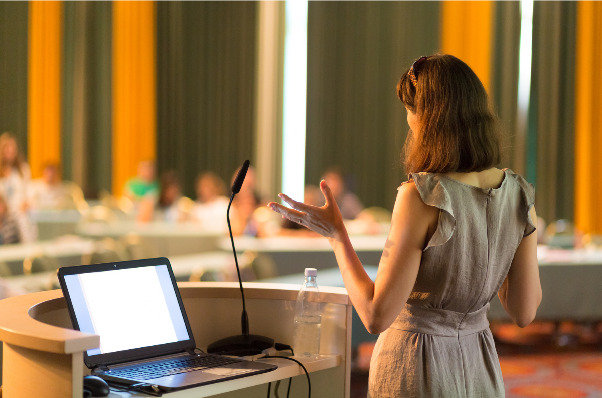 Coach speaking at a conference